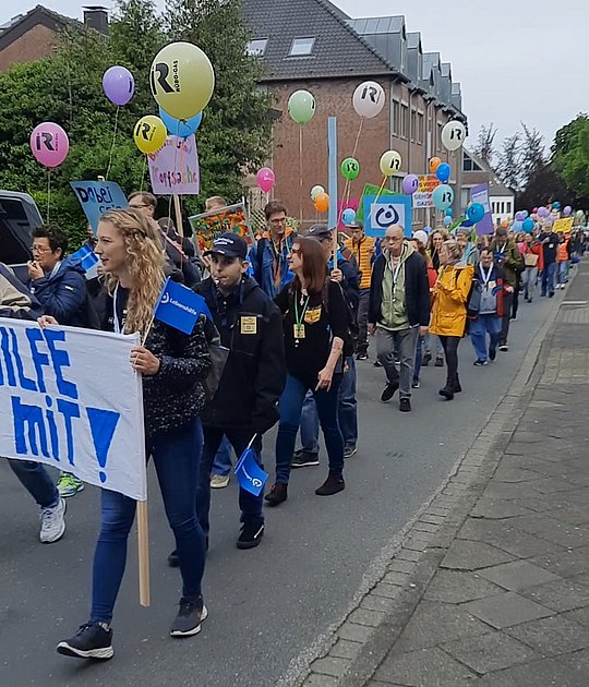 Demonstrierende Menschen mit Plakat "Gleiche Chancen für Alle"